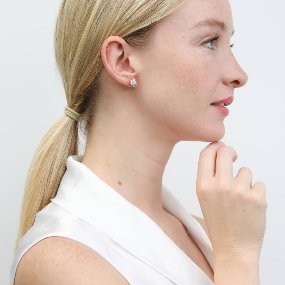 Model wearing Flower CZ Stud Earrings in Sterling Silver, Yellow Gold Flashed