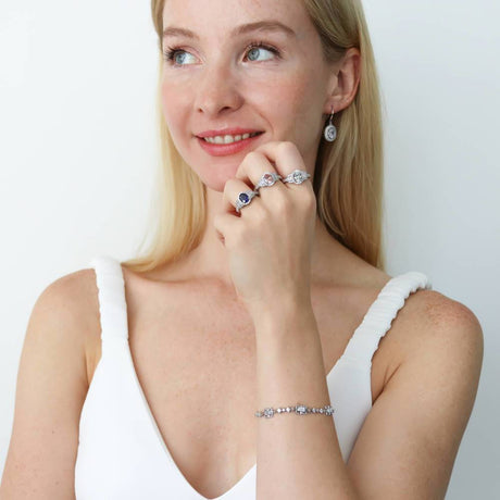 Model Wearing 3-Stone Ring, Art Deco Chain Bracelet, Halo Dangle Earrings
