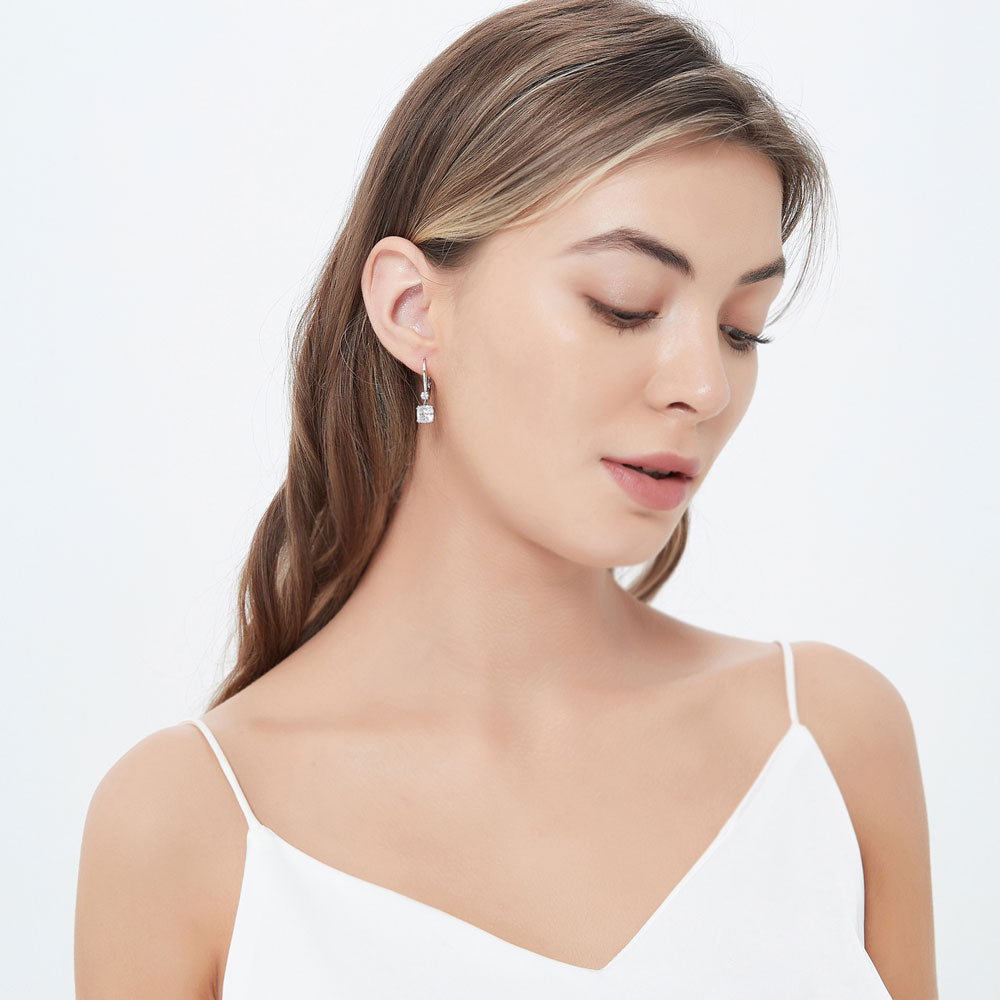Model wearing Solitaire 4ct Cushion CZ Leverback Dangle Earrings in Sterling Silver, 3 of 4