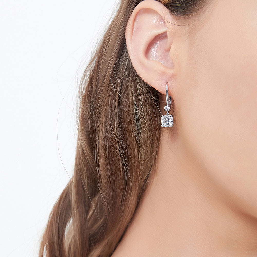 Model wearing Solitaire 4ct Cushion CZ Leverback Dangle Earrings in Sterling Silver, 2 of 4