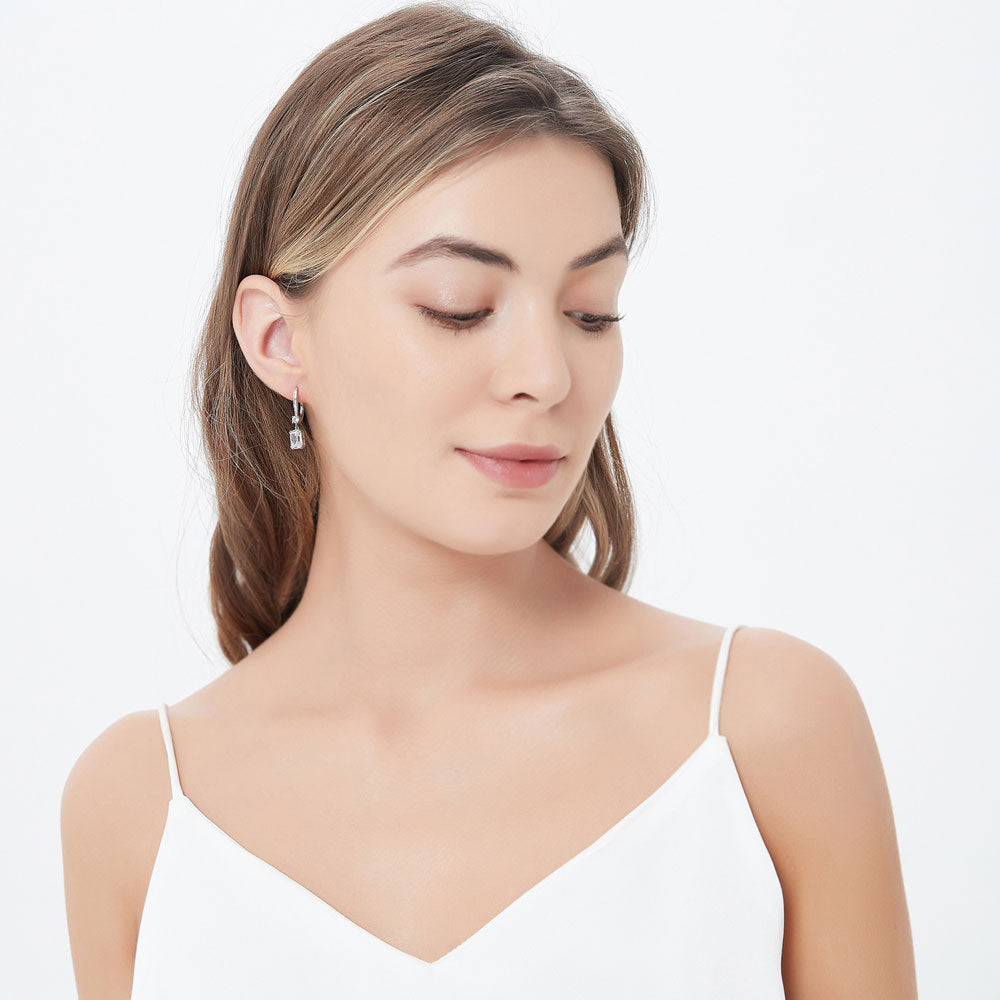 Model wearing Solitaire 3.2ct Cushion CZ Leverback Dangle Earrings in Sterling Silver, 3 of 4