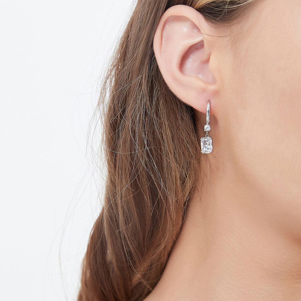 Model wearing Solitaire 3.2ct Cushion CZ Leverback Dangle Earrings in Sterling Silver, 2 of 4