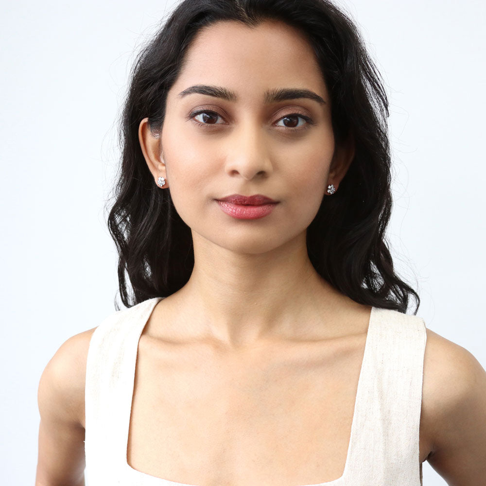 Model wearing Flower CZ Stud Earrings in Sterling Silver, Rhodium Plated