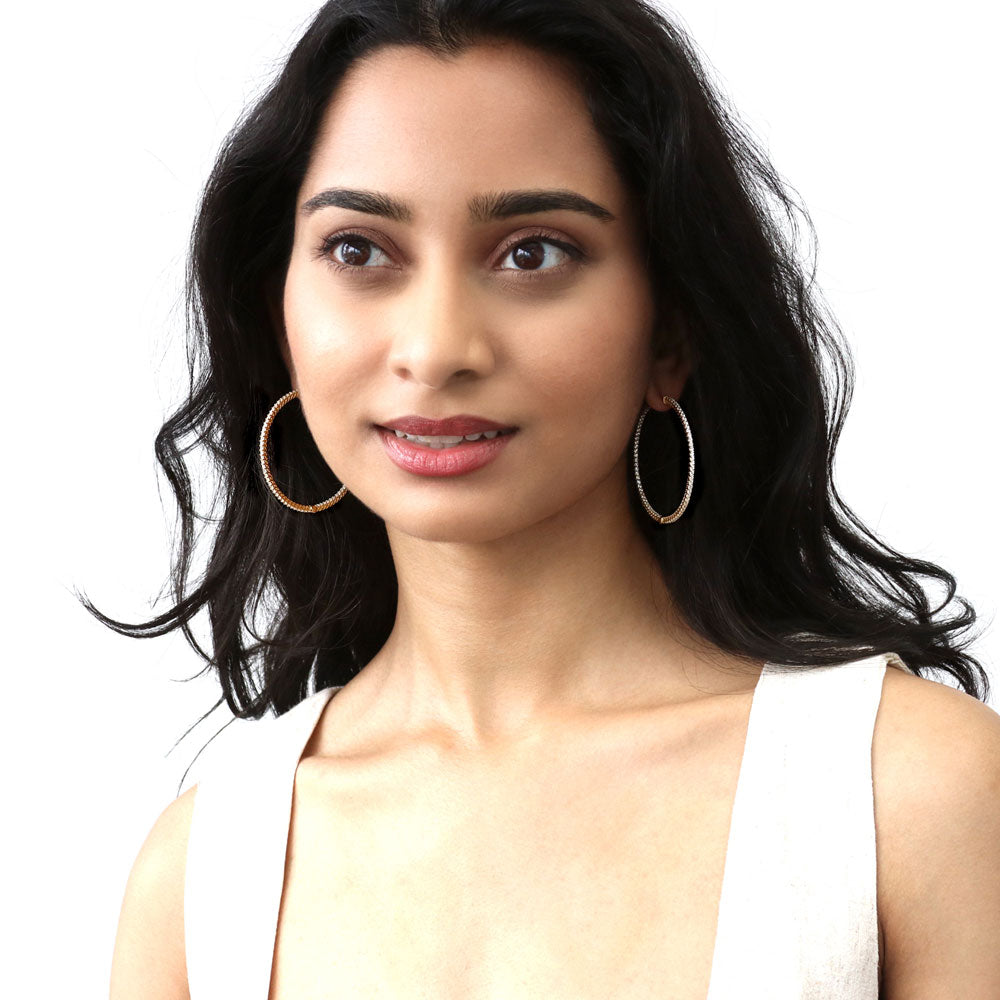 Model wearing CZ Large Inside-Out Hoop Earrings in Sterling Silver 2 inch, Yellow Gold Flashed