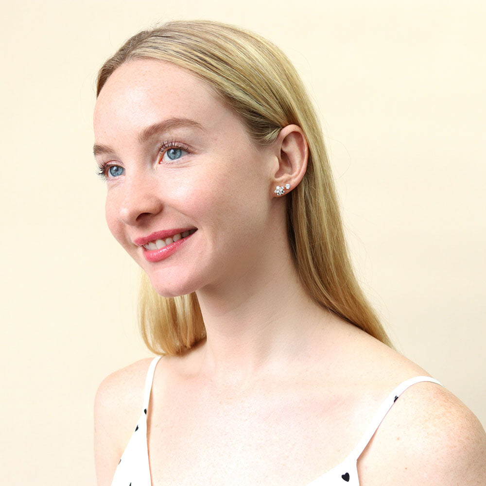 Model wearing Flower CZ Stud Earrings in Sterling Silver, Yellow Gold Flashed