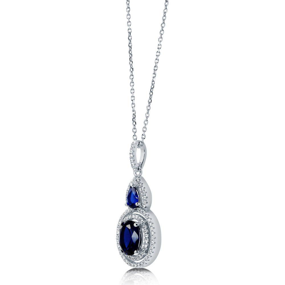 Angle view of Halo Simulated Blue Sapphire Oval CZ Necklace in Sterling Silver, 5 of 6
