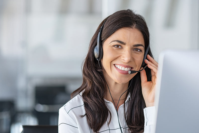 Smiling female customer service wearing headset.