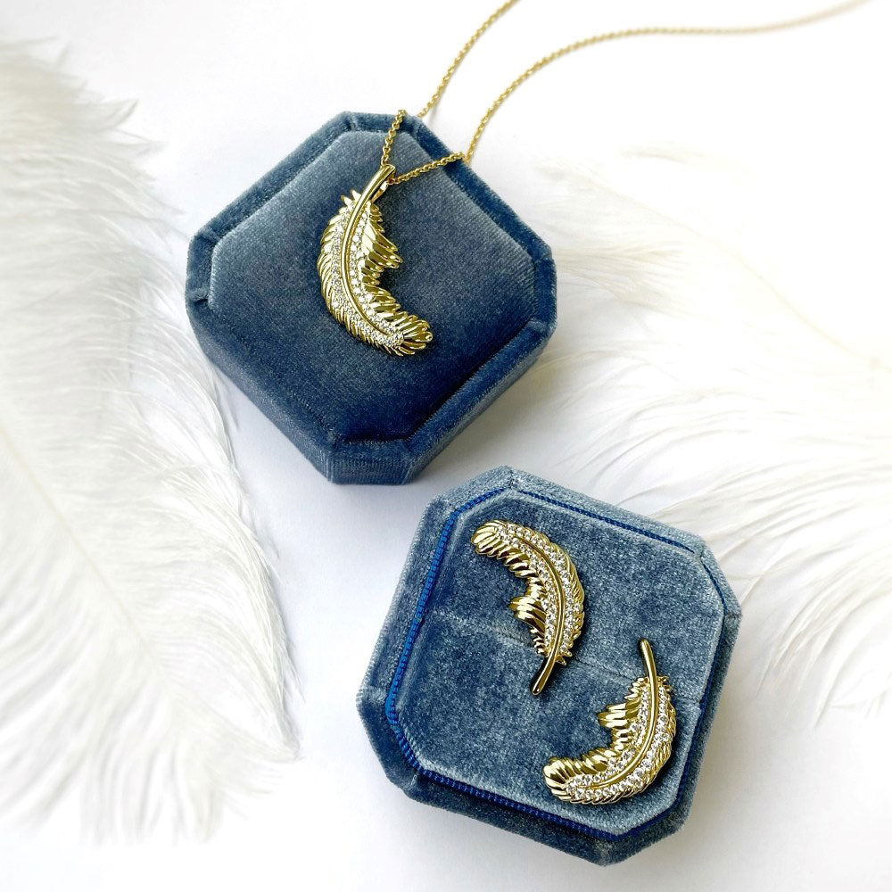 Flatlay view of Feather CZ Stud Earrings in Sterling Silver, Yellow Gold Flashed