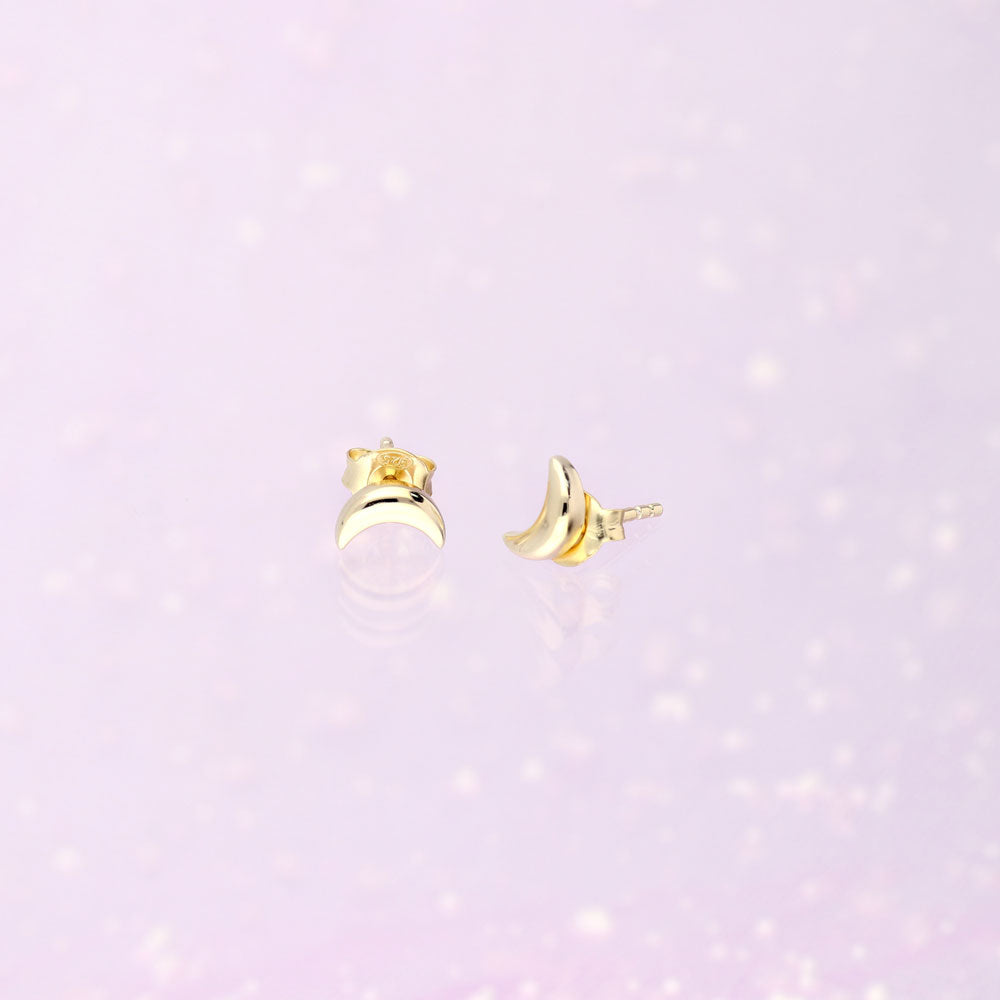 Flatlay view of Crescent Moon Stud Earrings in Sterling Silver, Yellow Gold Flashed