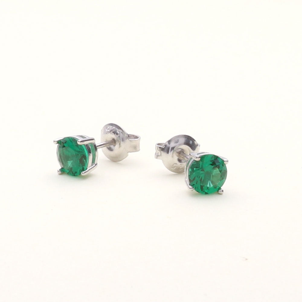 Flatlay view of Solitaire 1.6ct CZ Cartilage Stud Earrings in Sterling Silver, Emerald Color