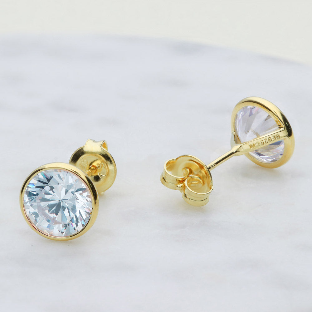 Flatlay view of Solitaire Bezel CZ Stud Earrings in Gold Flashed Sterling Silver, 8mm