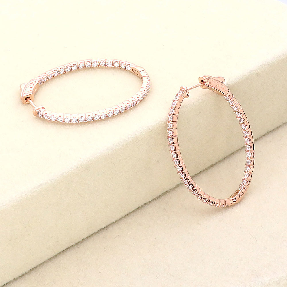 Flatlay view of Oval CZ Inside-Out Hoop Earrings in Sterling Silver 1.4 inch, Rhodium Plated