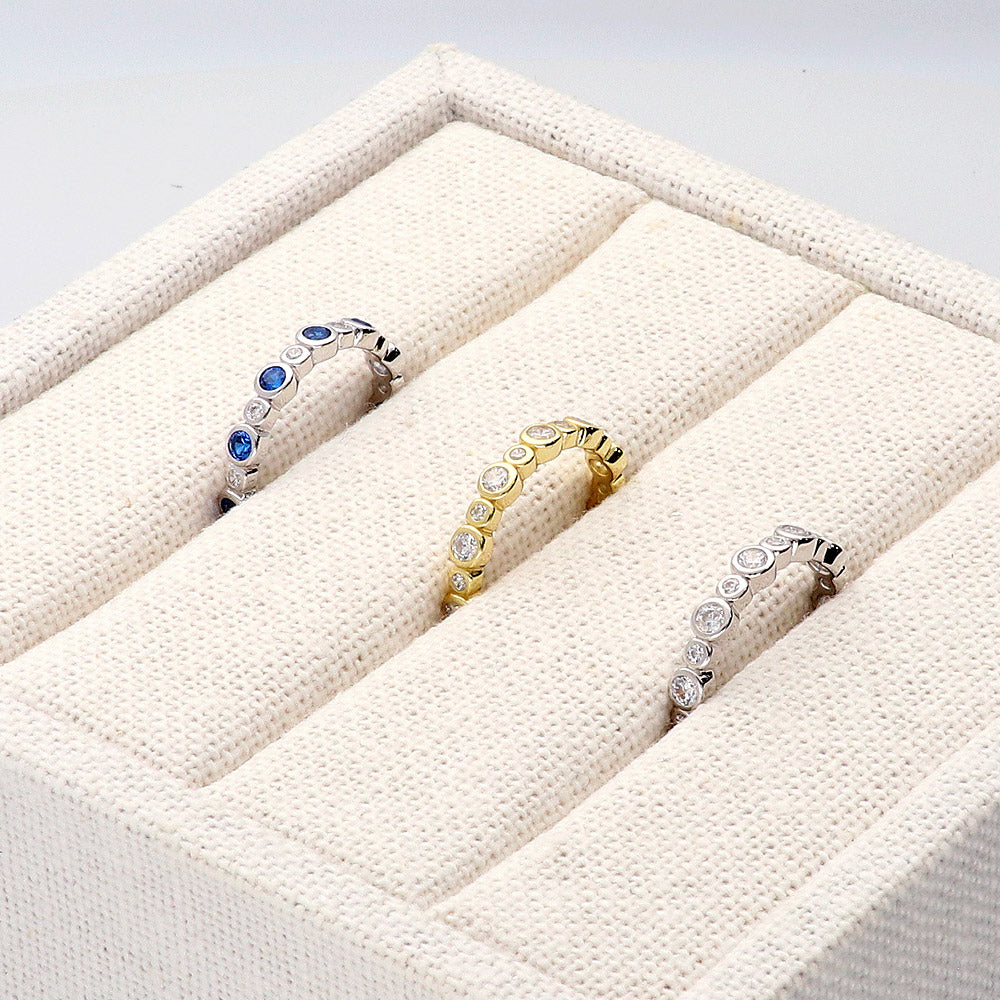 Flatlay view of Bubble Sapphire-Blue Bezel CZ Eternity Ring in Sterling Silver, 4 of 12