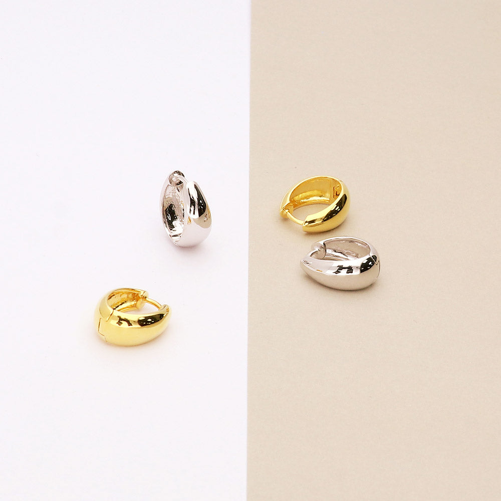 Flatlay view of Oval Dome Small Huggie Earrings in Sterling Silver 0.6 inch