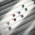 Flatlay view of Solitaire 2-Stone 1.4ct Pear CZ Stud Earrings in Sterling Silver