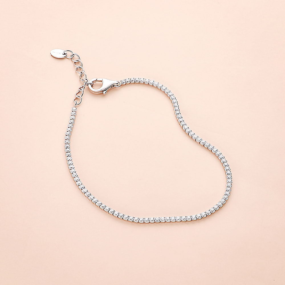 Flatlay view of CZ Necklace and Bracelet in Sterling Silver, Yellow Gold Flashed, Black