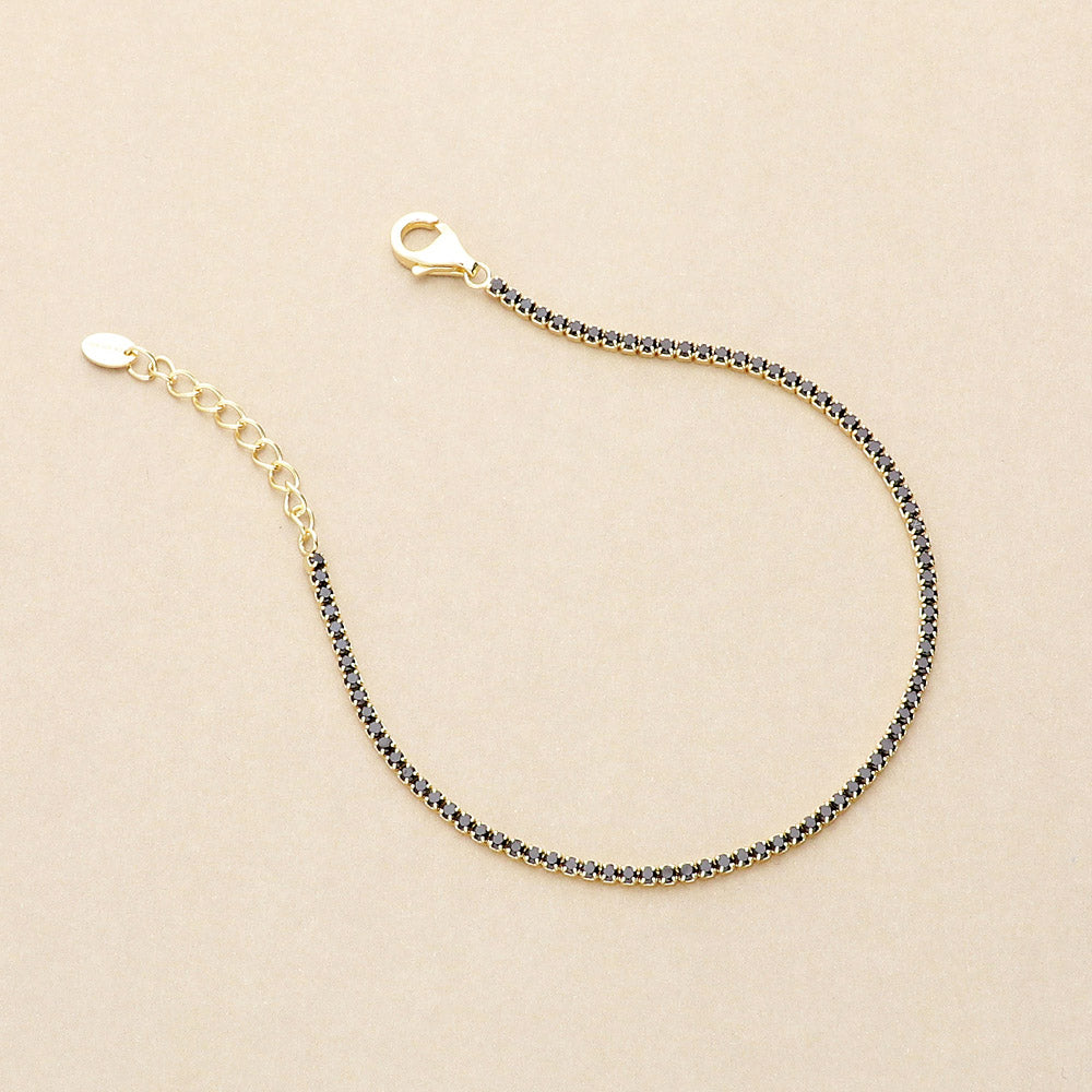 Flatlay view of CZ Necklace and Bracelet in Sterling Silver, Yellow Gold Flashed, Black