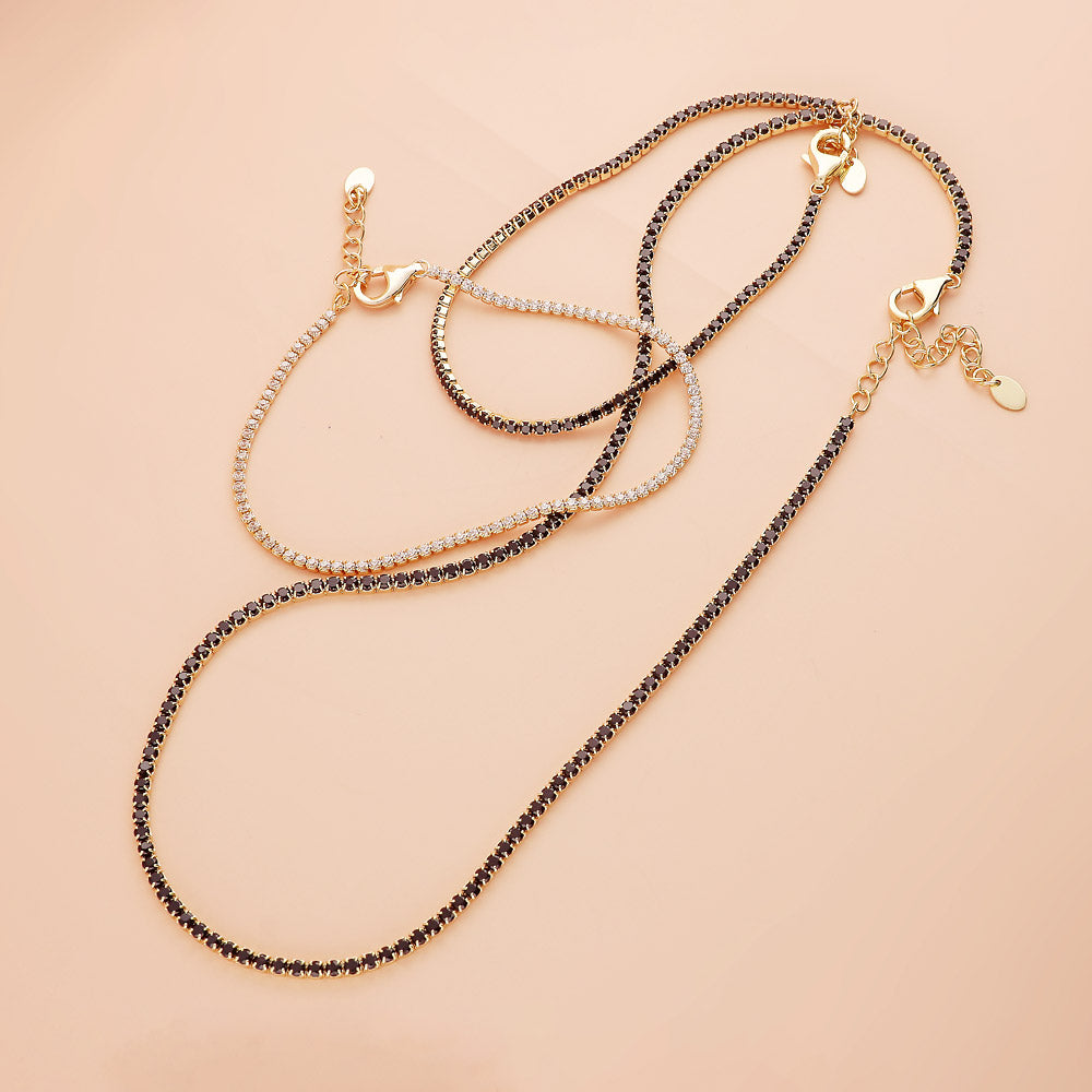 Flatlay view of CZ Necklace and Bracelet in Sterling Silver, Yellow Gold Flashed, Black
