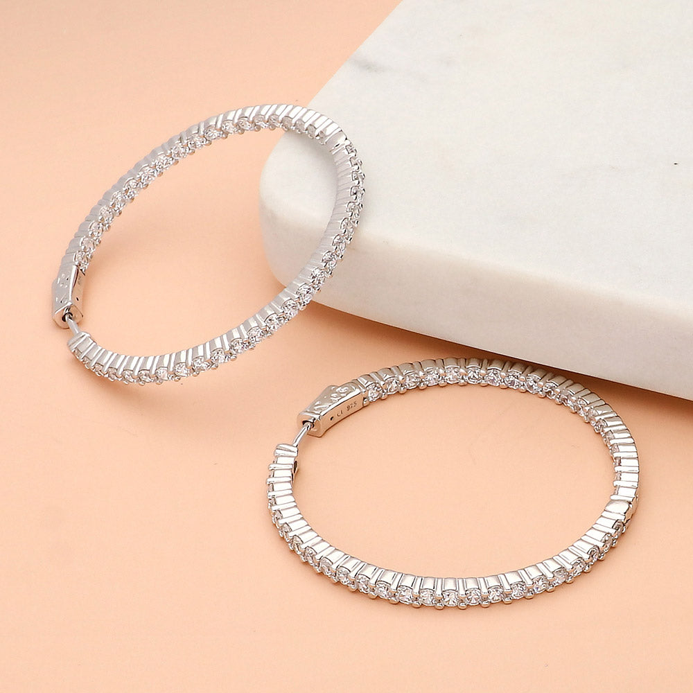 Flatlay view of CZ Large Inside-Out Hoop Earrings in Sterling Silver 1.8 inch, Rhodium Plated