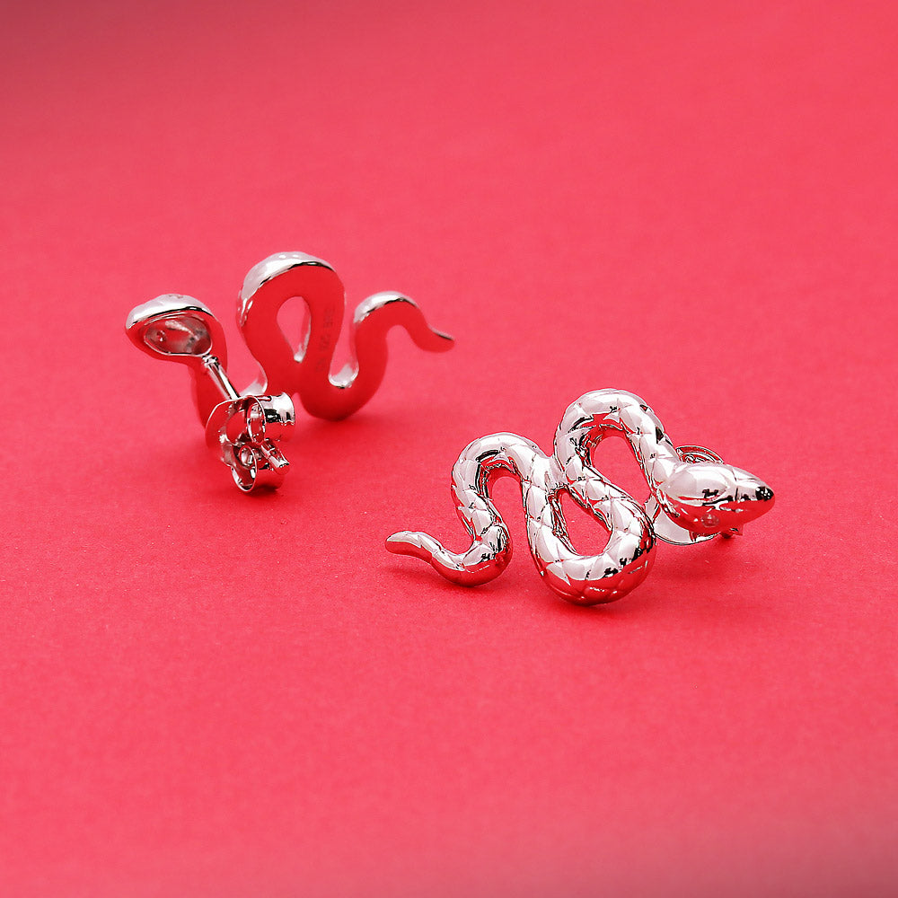 Flatlay view of Snake CZ Stud Earrings in Sterling Silver, Yellow Gold Flashed