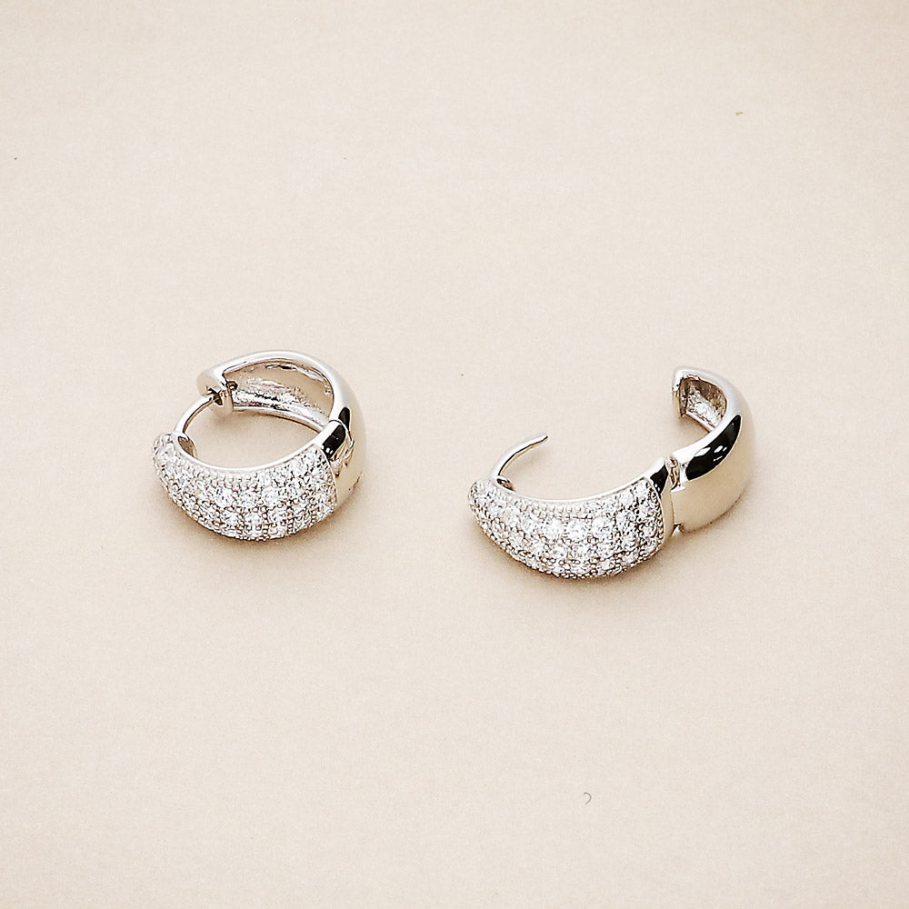 Flatlay view of Dome CZ Small Huggie Earrings in Sterling Silver 0.55 inch, 2 of 3