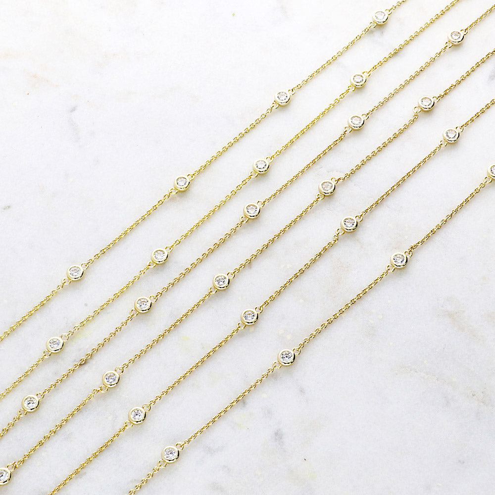 Flatlay view of Station CZ Station Necklace in Sterling Silver, Yellow Gold Flashed / 16 inch + 2 inch extension