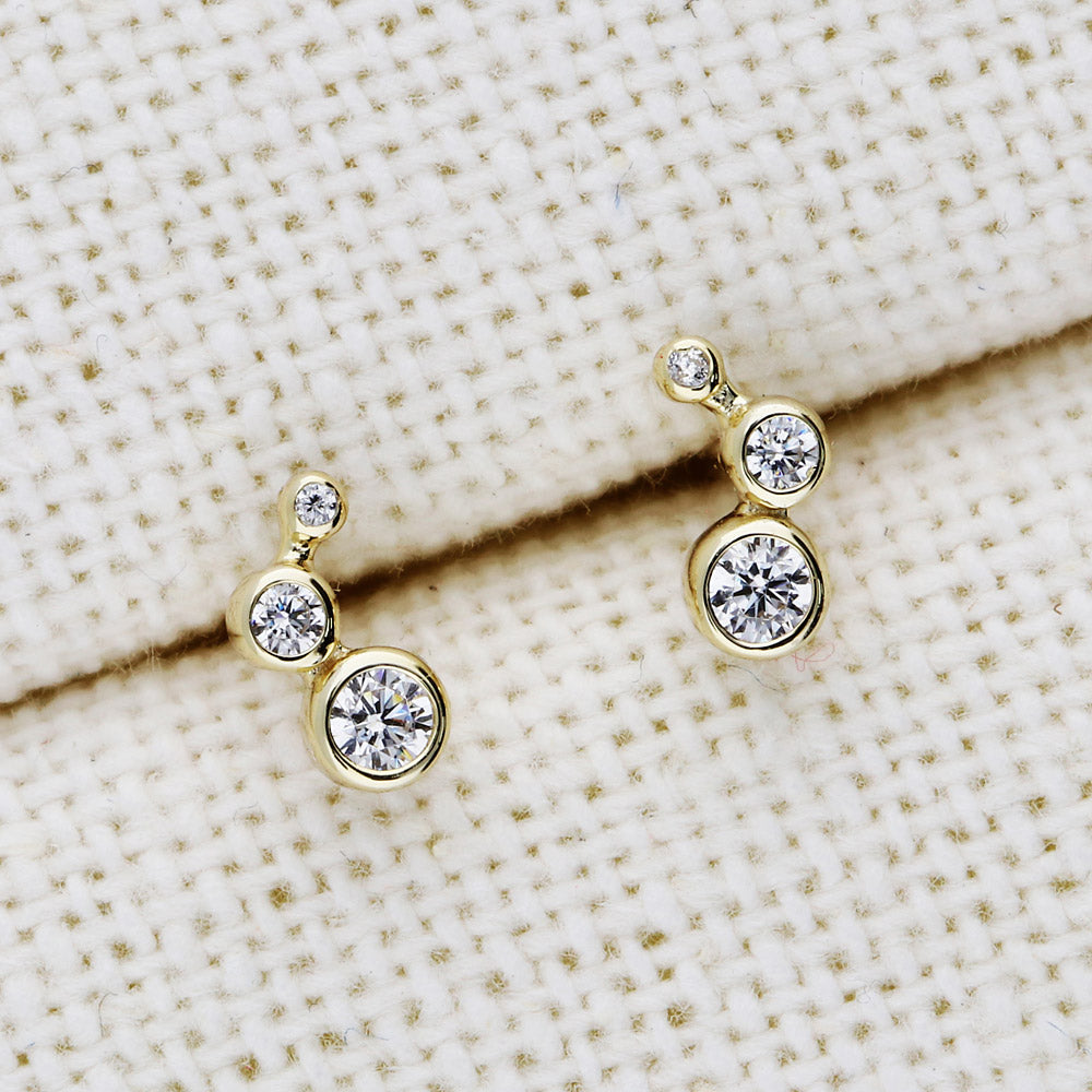 Flatlay view of Cartilage Graduated CZ Cartilage Stud Earrings in Sterling Silver, Yellow Gold Flashed