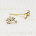 Flatlay view of Cartilage Graduated CZ Cartilage Stud Earrings in Sterling Silver, Yellow Gold Flashed