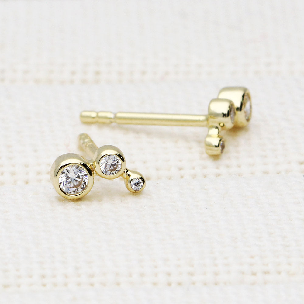 Flatlay view of Cartilage Graduated CZ Cartilage Stud Earrings in Sterling Silver, Yellow Gold Flashed