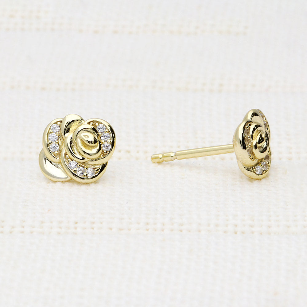 Flatlay view of Rose Flower CZ Cartilage Stud Earrings in Sterling Silver, Yellow Gold Flashed