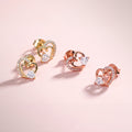 Flatlay view of Open Heart CZ Stud Earrings in Sterling Silver, Rose Gold Flashed