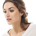 Model wearing Solitaire Cartilage CZ Cartilage Stud Earrings in Sterling Silver, Rose Gold Flashed