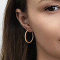 Model wearing CZ Small Hoop Earrings in Sterling Silver, 1 inch, Gold Flashed