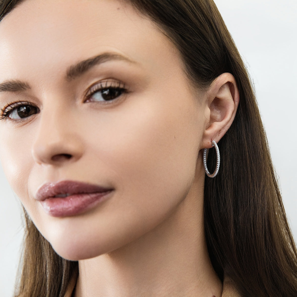 Model wearing CZ Small Hoop Earrings in Sterling Silver, 1 inch