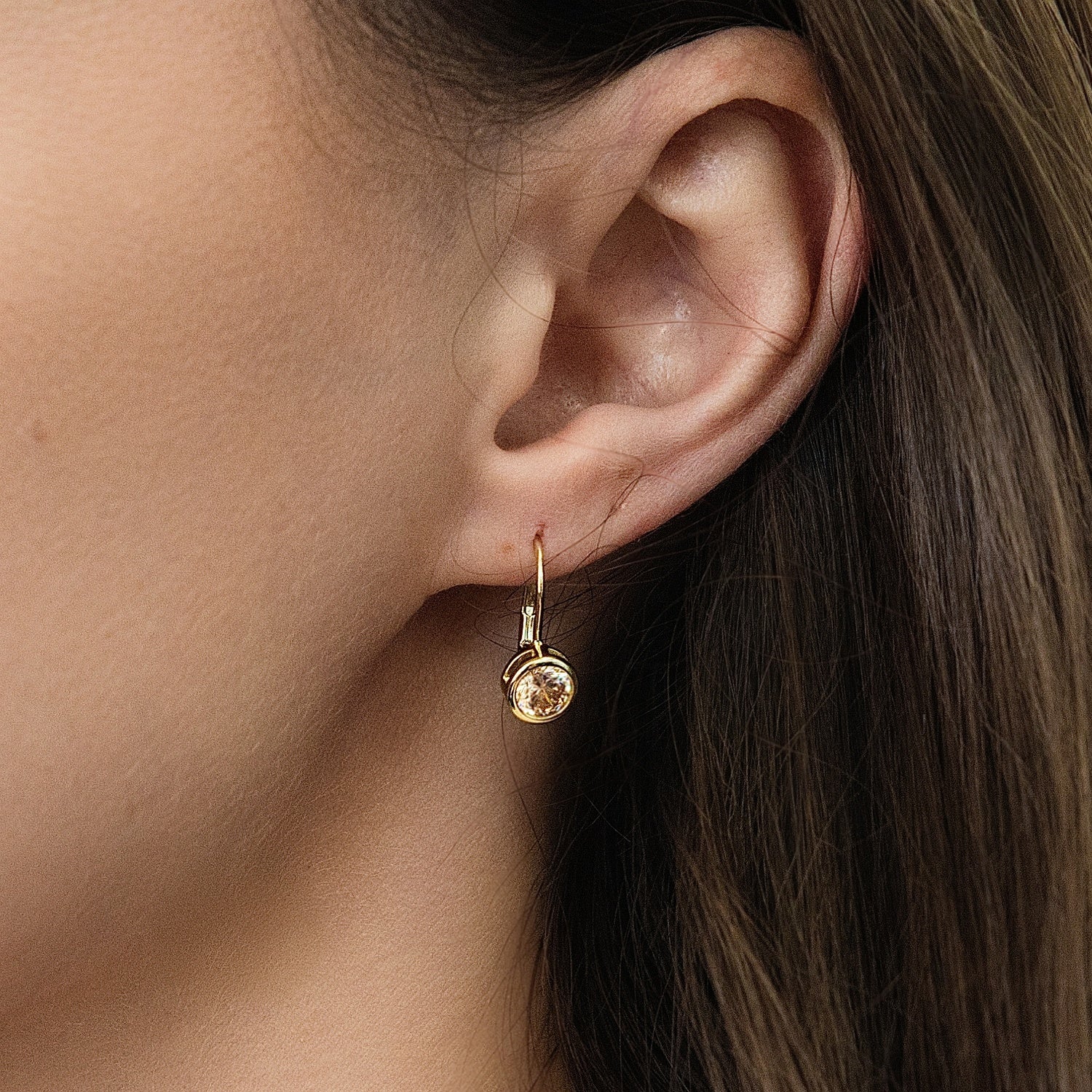 Model wearing Solitaire 1.2ct Bezel CZ Leverback Earrings in Sterling Silver, Champagne, Gold Flashed
