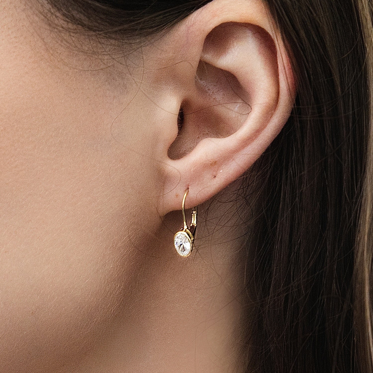 Model wearing Solitaire Oval Oval CZ Leverback Earrings in Sterling Silver, Gold Flashed