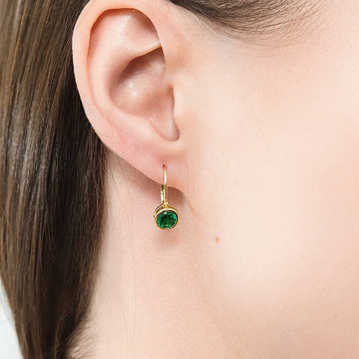 Model wearing Solitaire 1.2ct Bezel CZ Leverback Earrings in Sterling Silver, Green, Gold Flashed