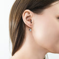 Model wearing Solitaire Oval Oval CZ Leverback Earrings in Sterling Silver, Rhodium Plated
