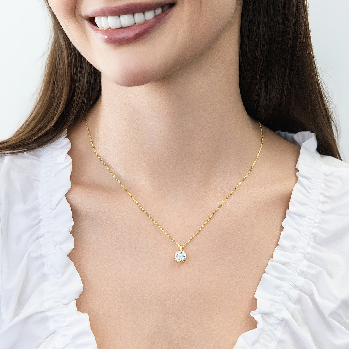Model wearing Solitaire 1.25ct Bezel CZ Necklace in Sterling Silver, Gold Flashed
