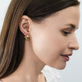 Model wearing Dome Mini Huggie Earrings 0.5 inch, Gold Flashed