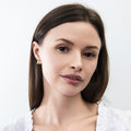 Model wearing Dome Mini Huggie Earrings 0.5 inch, Gold Flashed