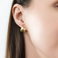 Model wearing Dome Mini Huggie Earrings 0.5 inch, Gold Flashed