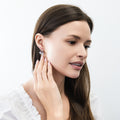 Model wearing Solitaire 1.6-2.6ct Pear CZ Leverback Earrings in Sterling Silver, Clear