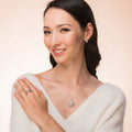 Model wearing Clover CZ Small Huggie Earrings in Sterling Silver 0.55 inch, Yellow Gold Flashed