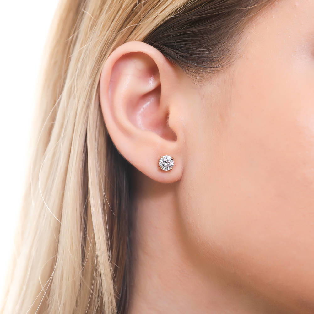 Model wearing Solitaire 1.6ct CZ Stud Earrings in Sterling Silver, Yellow Gold Flashed / Clear