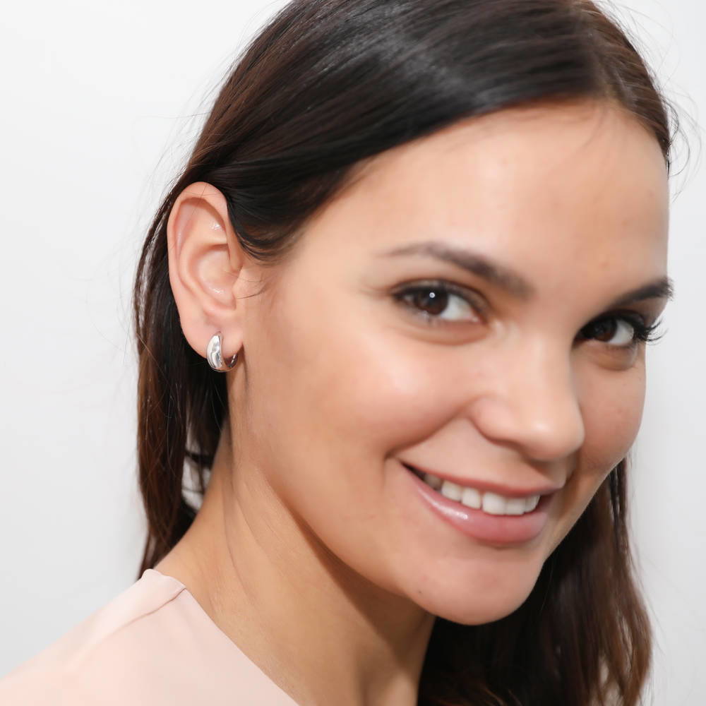 Model wearing Dome CZ Small Huggie Earrings in Sterling Silver 0.6 inch, Rhodium Plated