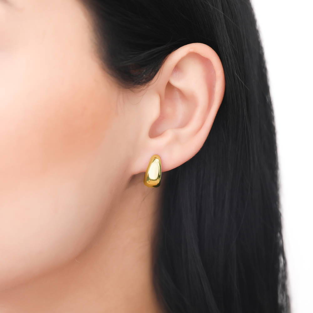 Model wearing Dome CZ Small Huggie Earrings in Sterling Silver 0.6 inch, Yellow Gold Flashed