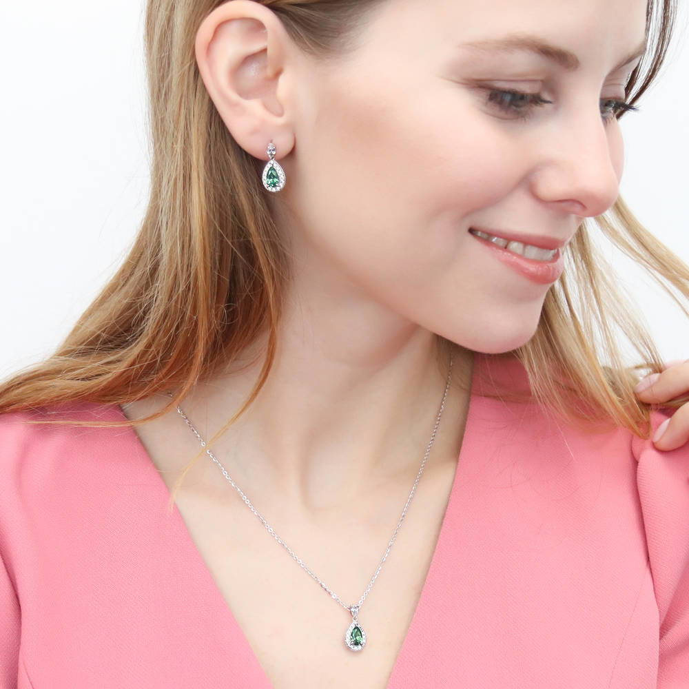 Model wearing Halo Pear CZ Earrings in Sterling Silver, Blue Color