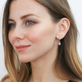 Model wearing Solitaire CZ Cartilage Huggie Earrings in Sterling Silver 0.5 inch, Yellow Gold Flashed / Round Cut
