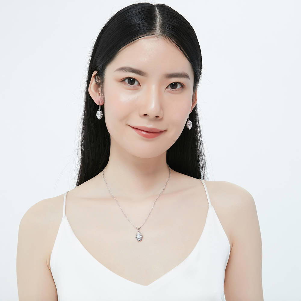 Model wearing Solitaire Filigree Oval CZ Fish Hook Earrings in Sterling Silver, 7 of 7